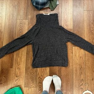 black turtleneck sweatshirt with front pockets